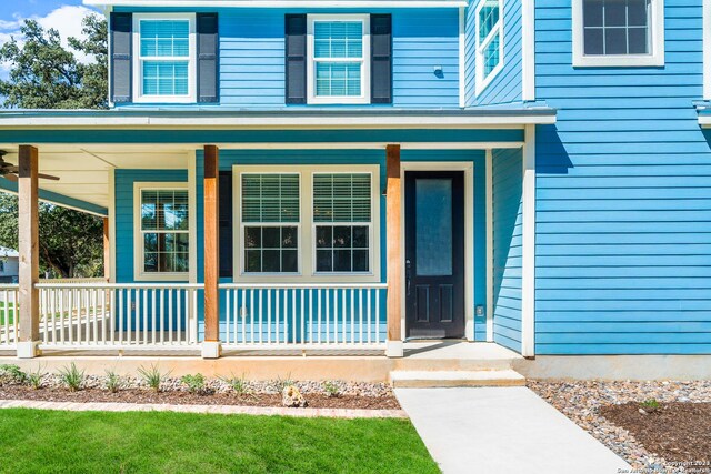 view of exterior entry with covered porch