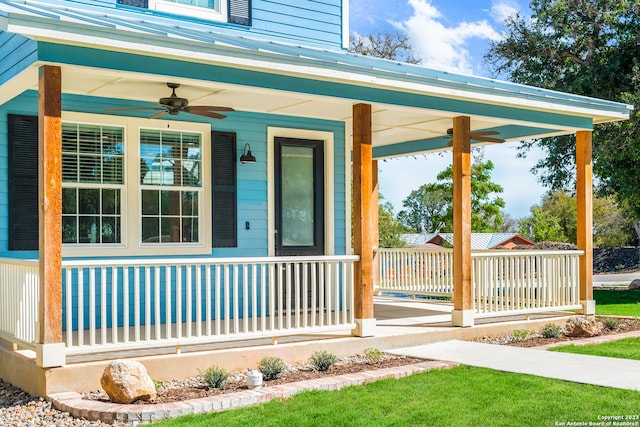 view of exterior entry with covered porch and ceiling fan