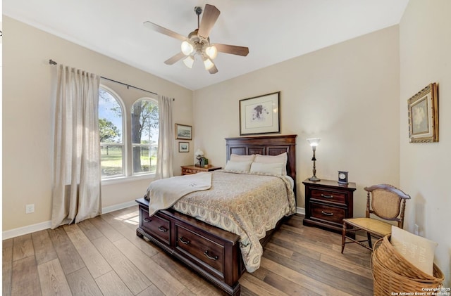 bedroom featuring baseboards, ceiling fan, and hardwood / wood-style flooring