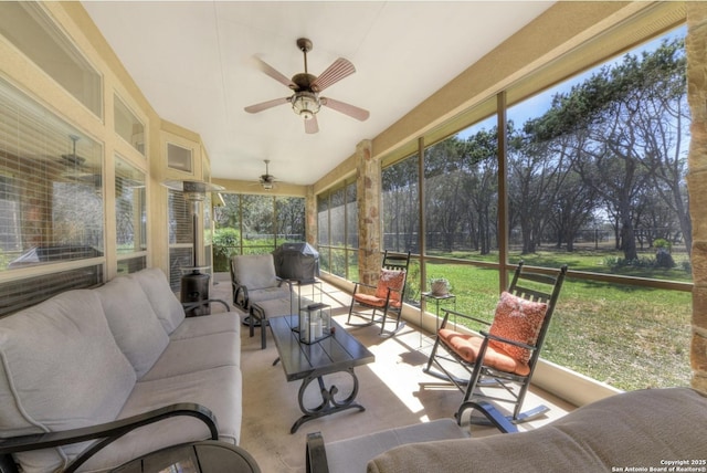 sunroom / solarium with an outdoor living space and a ceiling fan