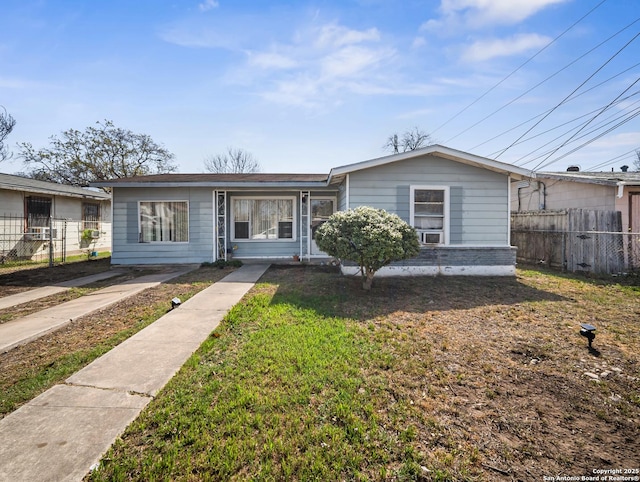 view of front of home with cooling unit, a front yard, and fence