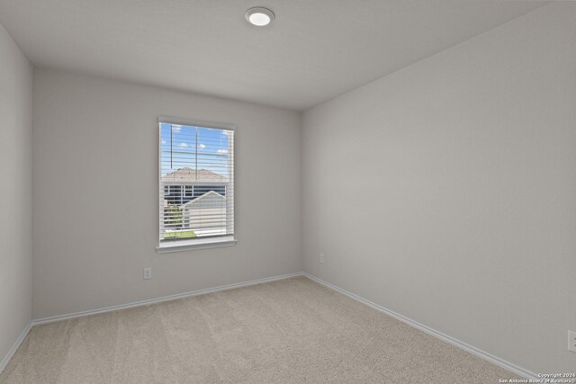 819 Bluegrass Pt, New Braunfels, TX 78130 - unfurnished room with baseboards and light colored carpet