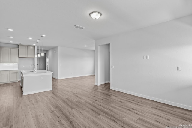 2074 Newforest Peak, New Braunfels, TX 78130 - unfurnished living room with baseboards, light wood-style flooring, recessed lighting, and a sink