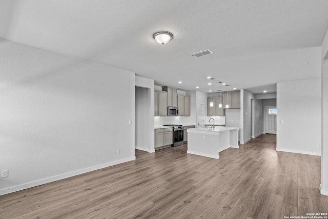 2074 Newforest Peak, New Braunfels, TX 78130 - unfurnished living room with a sink, light wood-style flooring, baseboards, and recessed lighting