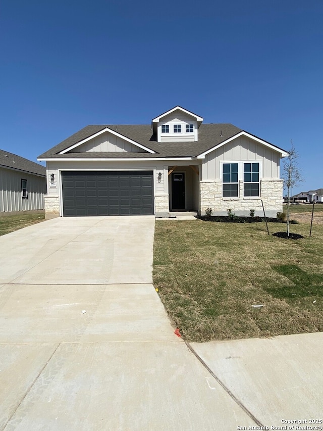 2059 Newforest Peak, New Braunfels, TX 78130 - view of front of property with board and batten siding, stone siding, a garage, driveway, and a front yard
