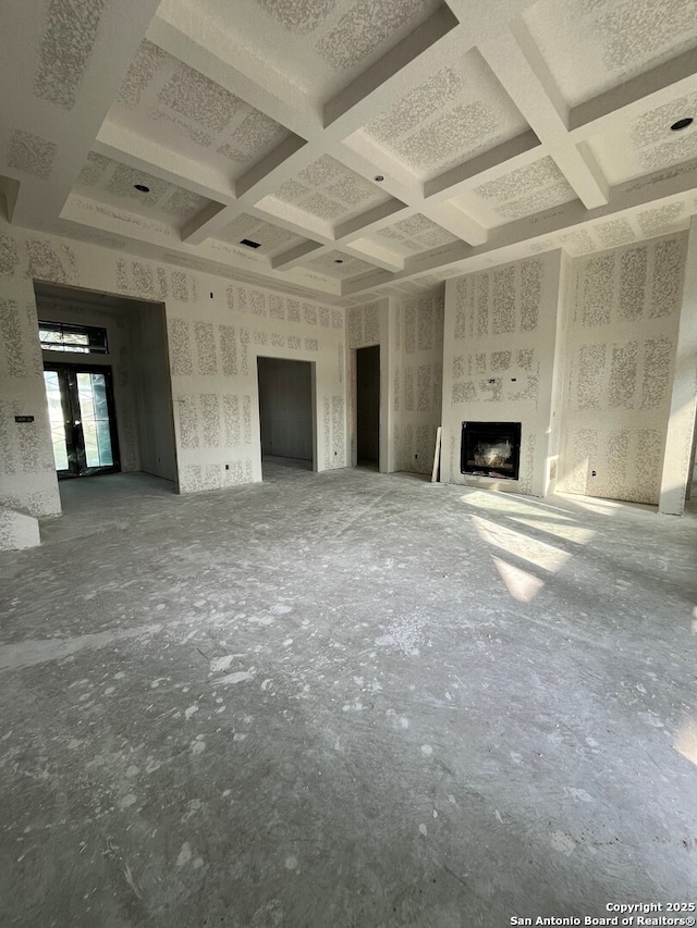 5668 Dry Comal, New Braunfels, TX 78132 - unfurnished living room featuring coffered ceiling, a fireplace, and beam ceiling