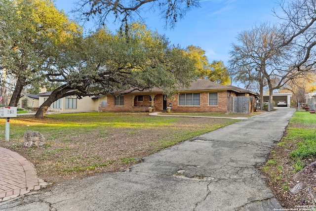262 Rockhill Dr, San Antonio, TX 78209 - view of front of home with brick siding, fence, and a front yard