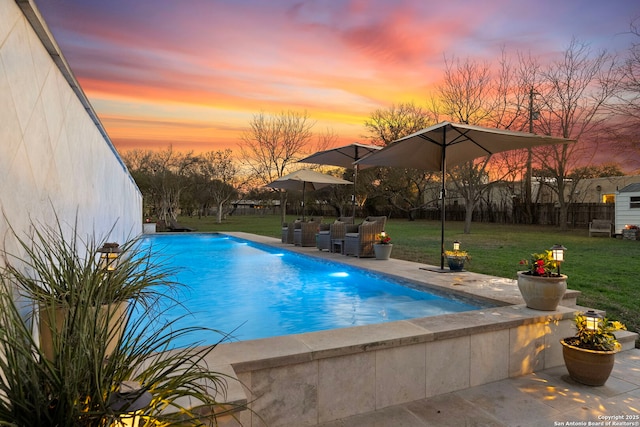 262 Rockhill Dr, San Antonio, TX 78209 - pool at dusk featuring fence, an outdoor pool, an outdoor living space, a yard, and a patio area