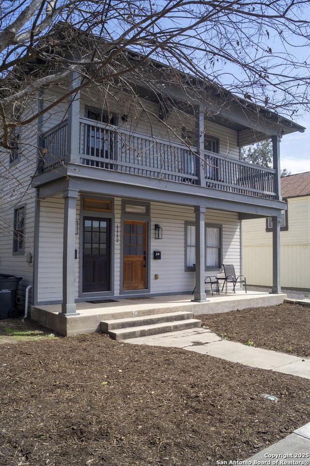 view of front of home featuring covered porch and a balcony