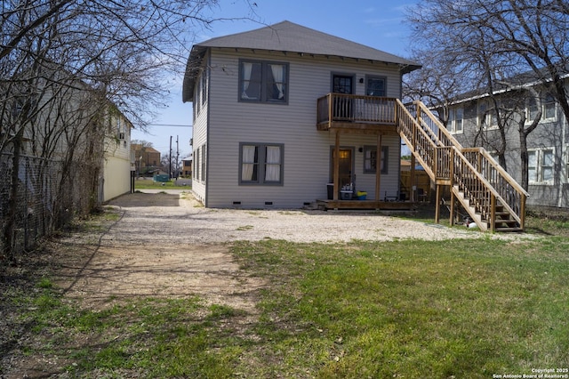 rear view of property with stairs, a deck, and a yard