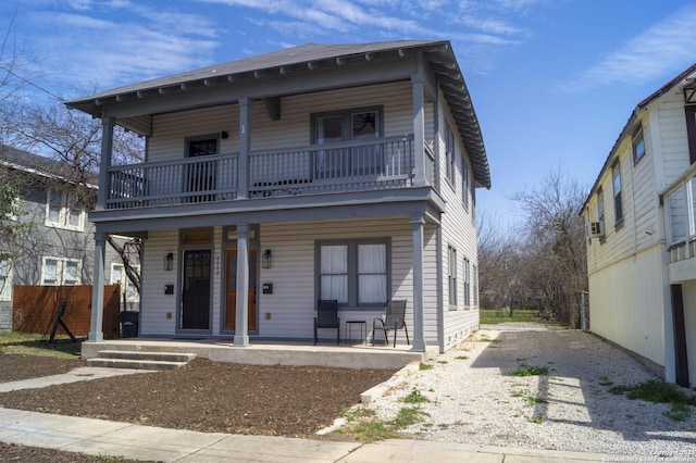 view of front facade featuring fence and a porch