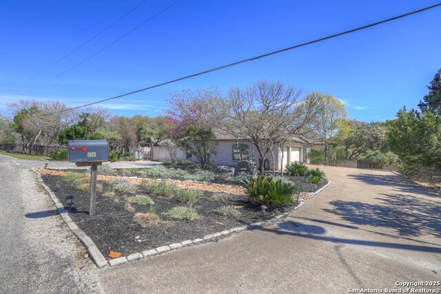 363 Buckhaven, Canyon Lake, TX 78133 - view of front facade featuring driveway, a garage, and fence
