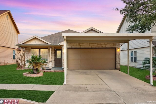 view of front of house with stone siding, concrete driveway, a garage, and a lawn