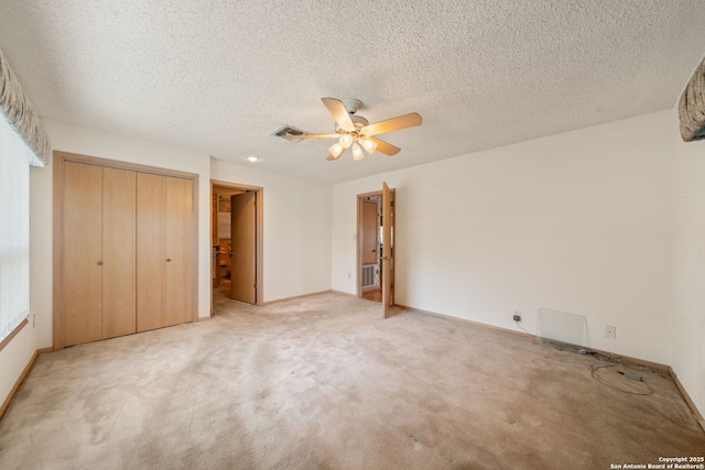 831 Hill Top, Canyon Lake, TX 78133 - unfurnished bedroom with a closet, a textured ceiling, visible vents, baseboards, and carpet floors
