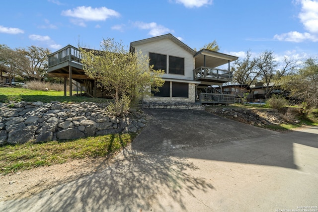 831 Hill Top, Canyon Lake, TX 78133 - view of front facade with stone siding and a wooden deck