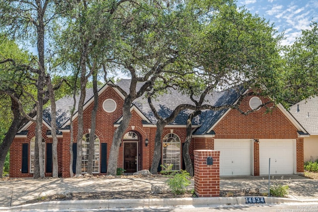 14834 Churchill Estates Blvd, San Antonio, TX 78248 - view of front of home featuring brick siding, driveway, an attached garage, and roof with shingles