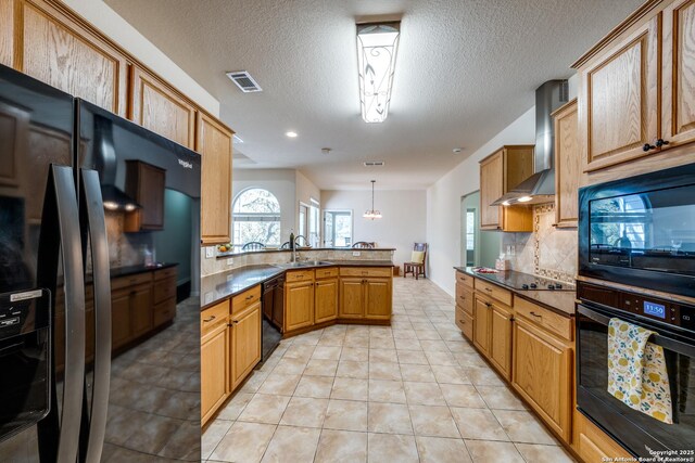 14834 Churchill Estates Blvd, San Antonio, TX 78248 - kitchen featuring black appliances, wall chimney exhaust hood, a sink, a peninsula, and tasteful backsplash
