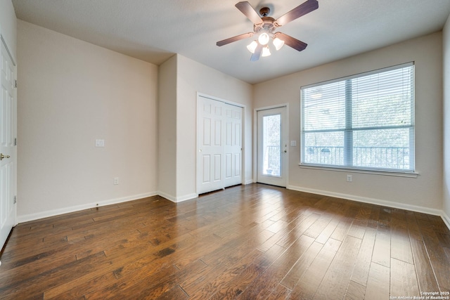 14834 Churchill Estates Blvd, San Antonio, TX 78248 - unfurnished bedroom with dark wood finished floors, multiple windows, access to exterior, and baseboards