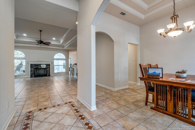 14834 Churchill Estates Blvd, San Antonio, TX 78248 - dining area featuring arched walkways, a tray ceiling, ornamental molding, a ceiling fan, and light tile patterned floors