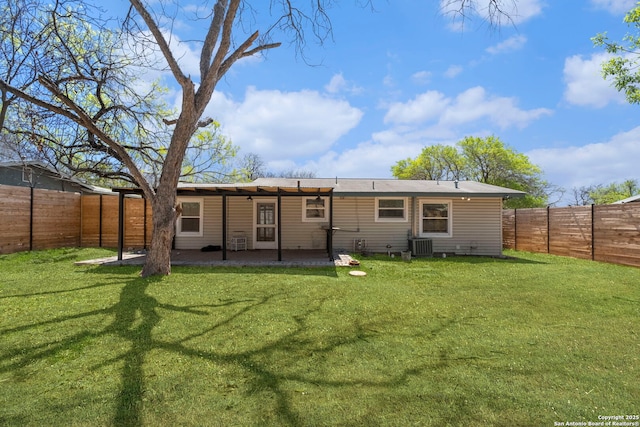 rear view of house featuring central AC, a fenced backyard, a yard, and a patio area