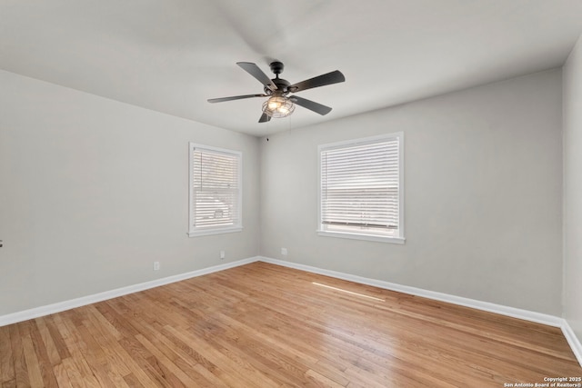 unfurnished room featuring a ceiling fan, baseboards, and light wood-style floors