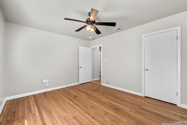 unfurnished bedroom with baseboards, visible vents, light wood-style flooring, and ceiling fan