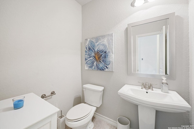 12007 White Riv, San Antonio, TX 78254 - bathroom with toilet, a sink, and baseboards