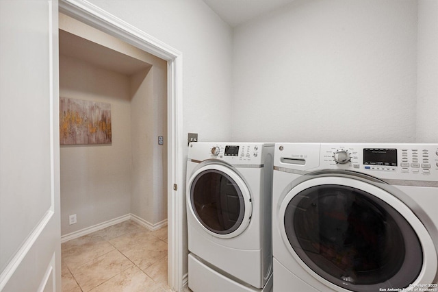 12007 White Riv, San Antonio, TX 78254 - clothes washing area with washing machine and clothes dryer, baseboards, laundry area, and light tile patterned floors
