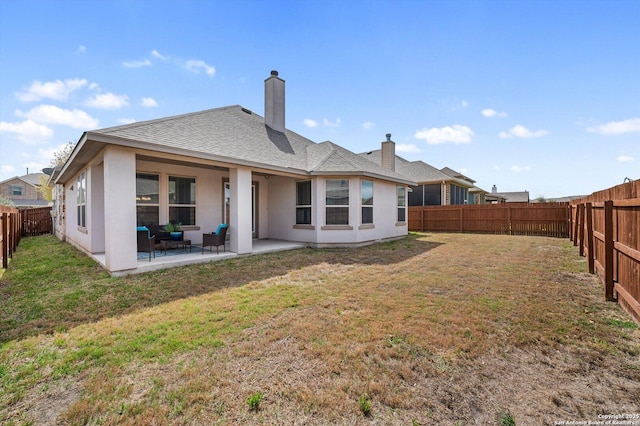 12007 White Riv, San Antonio, TX 78254 - rear view of house featuring roof with shingles, a patio, a fenced backyard, a yard, and a chimney