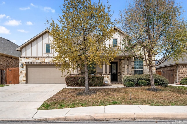 12007 White Riv, San Antonio, TX 78254 - view of front of house with stone siding, driveway, a garage, and fence