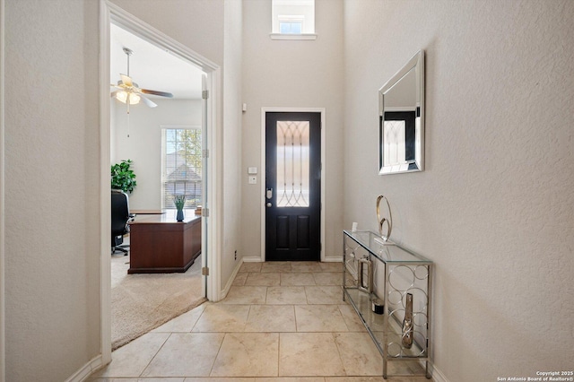 12007 White Riv, San Antonio, TX 78254 - foyer entrance featuring light colored carpet, light tile patterned floors, baseboards, and a ceiling fan