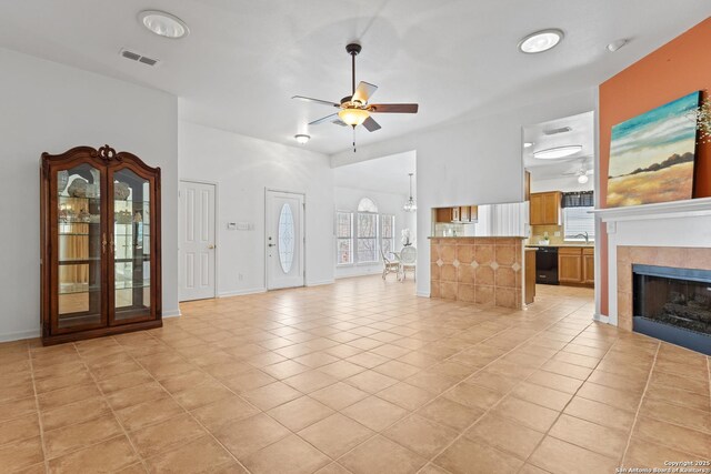 6615 Morning Shadow, San Antonio, TX 78256 - unfurnished living room with light tile patterned flooring, a tile fireplace, a ceiling fan, baseboards, and visible vents