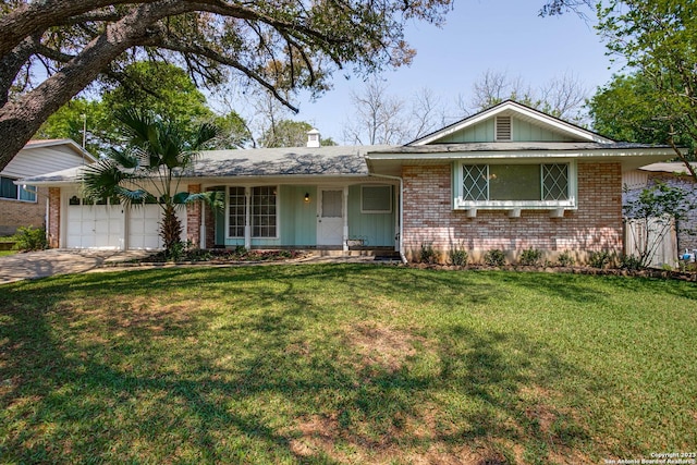 single story home featuring a front lawn, a garage, concrete driveway, and brick siding