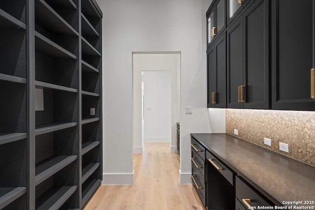 interior space with baseboards and light wood-style floors