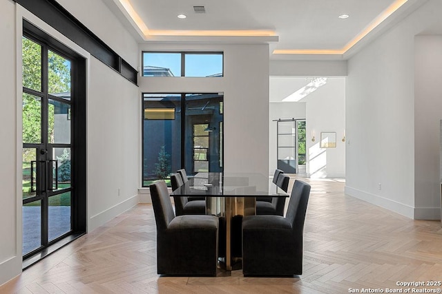 dining room featuring baseboards and plenty of natural light