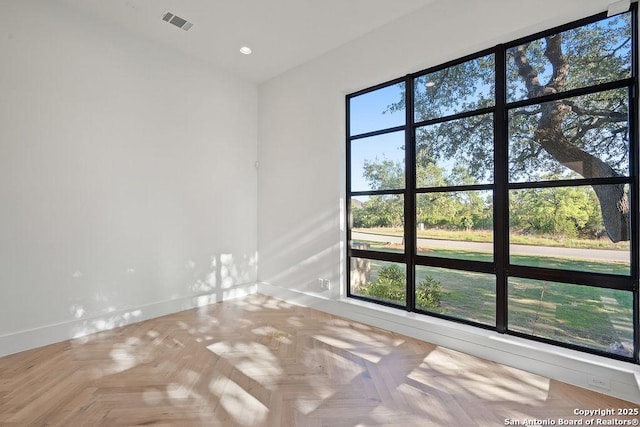 empty room with baseboards, visible vents, and recessed lighting