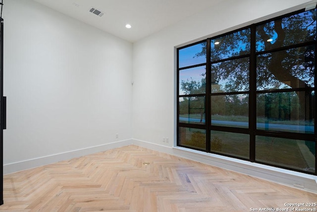 unfurnished room featuring recessed lighting, visible vents, and baseboards