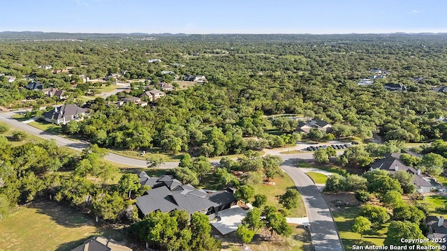 birds eye view of property featuring a residential view and a wooded view