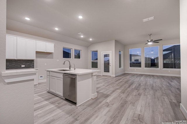 9331 Pioneer Jct, San Antonio, TX 78254 - kitchen featuring dishwasher, light wood-style floors, white cabinetry, light countertops, and an island with sink