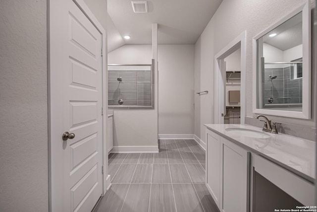 9331 Pioneer Jct, San Antonio, TX 78254 - bathroom featuring vanity, a spacious closet, tiled shower, vaulted ceiling, and recessed lighting
