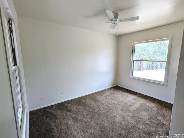 spare room with baseboards, ceiling fan, and carpet