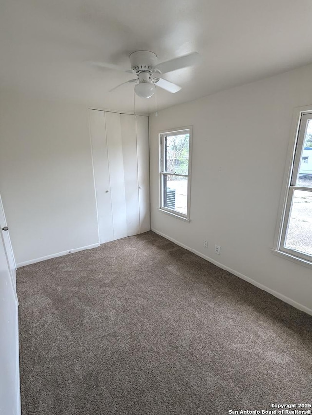unfurnished bedroom with a ceiling fan, carpet floors, baseboards, and a closet