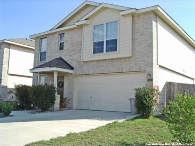 traditional home with concrete driveway and a garage