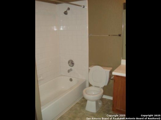 full bath with bathtub / shower combination, toilet, and vanity