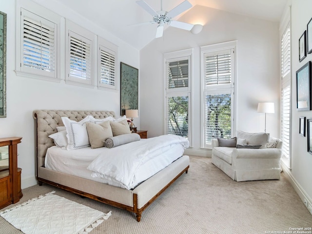 carpeted bedroom featuring baseboards, multiple windows, and vaulted ceiling