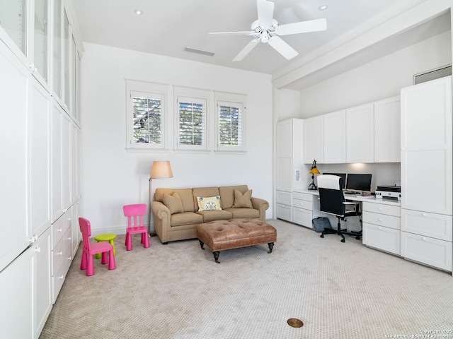 interior space with baseboards, ceiling fan, light carpet, and visible vents