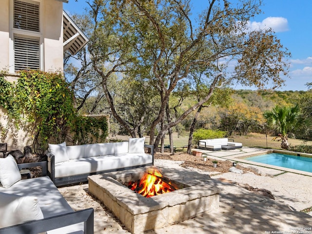 exterior space featuring an outdoor living space with a fire pit and an outdoor pool