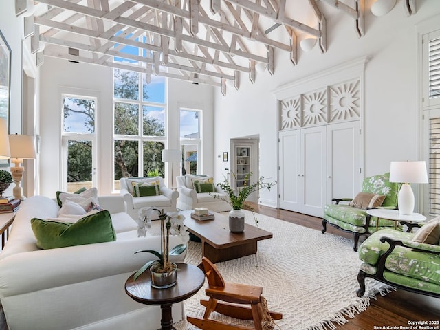 sunroom / solarium featuring beamed ceiling