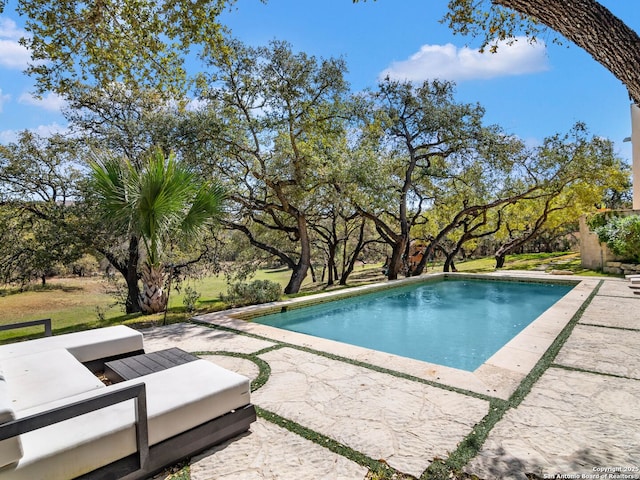 outdoor pool with outdoor lounge area and a patio area
