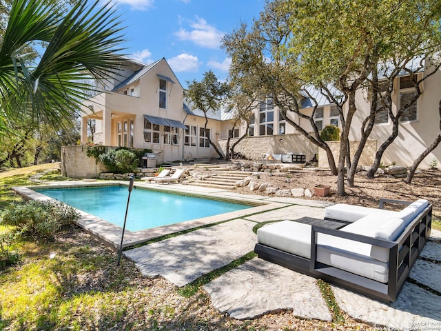 pool featuring a patio and an outdoor living space